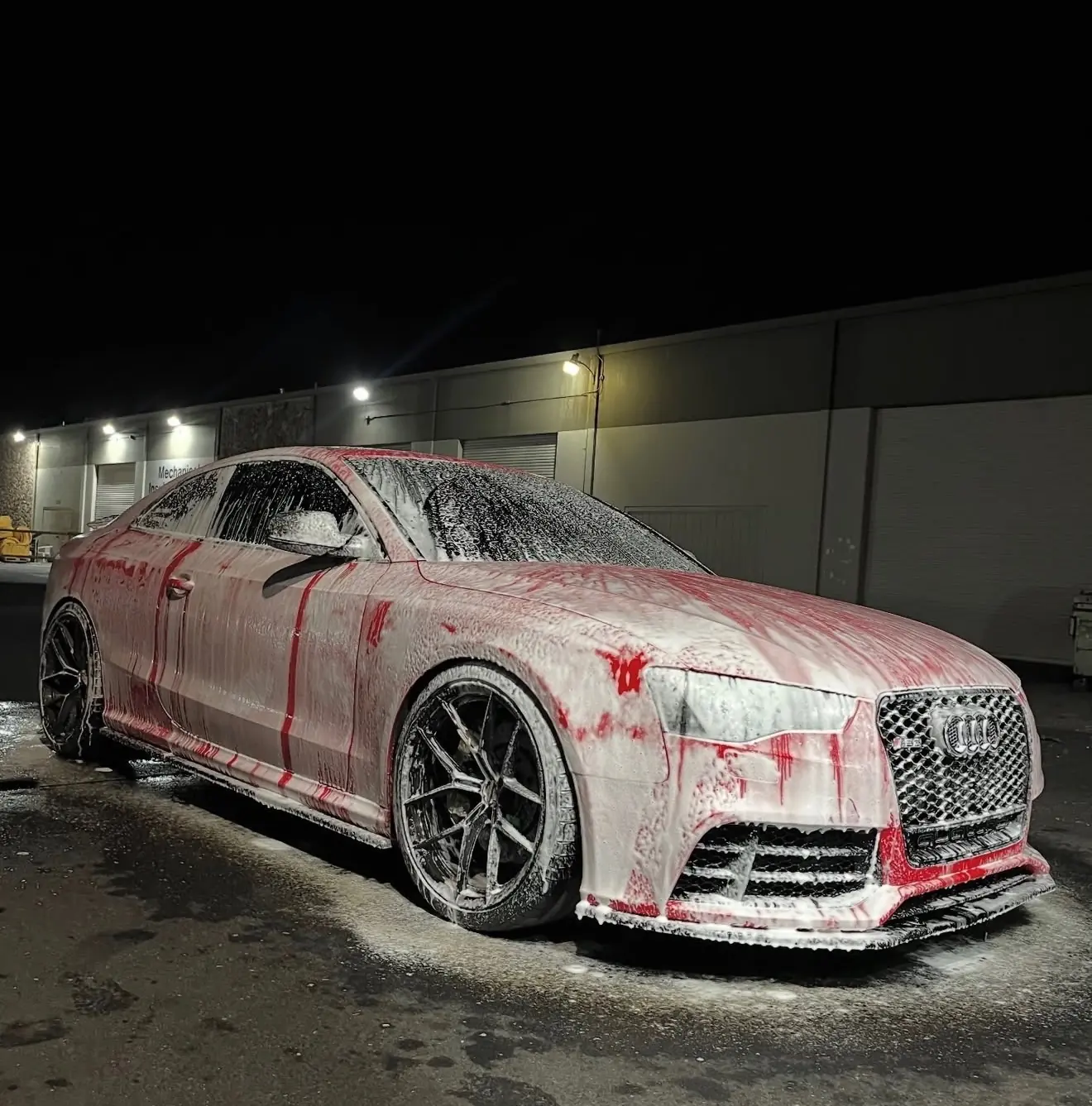 Red Audi covered in snow foam during a Cali Performance Detailing session