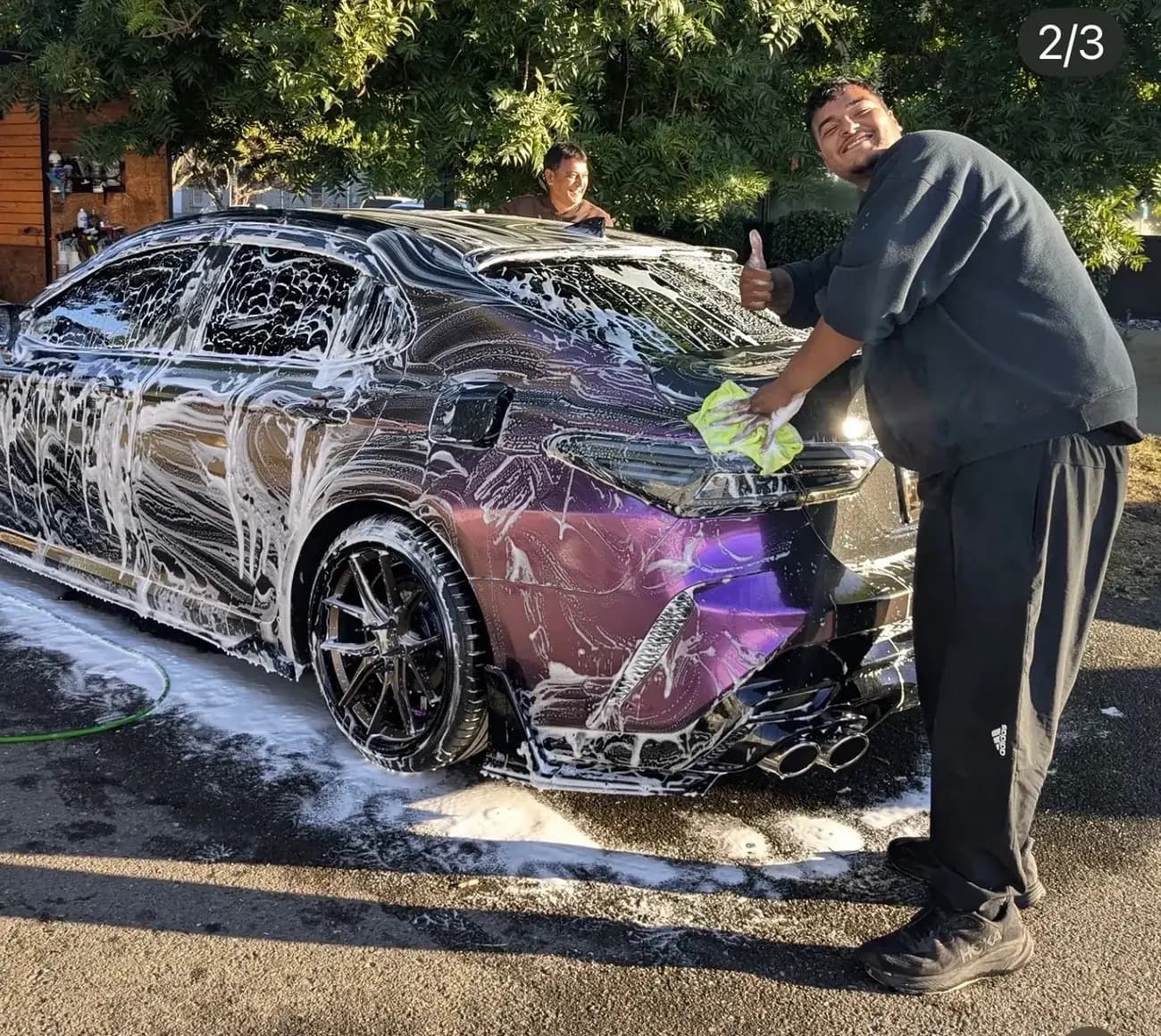 Colour-shift Toyota Camry covered in snow foam with the CPD crew alongside