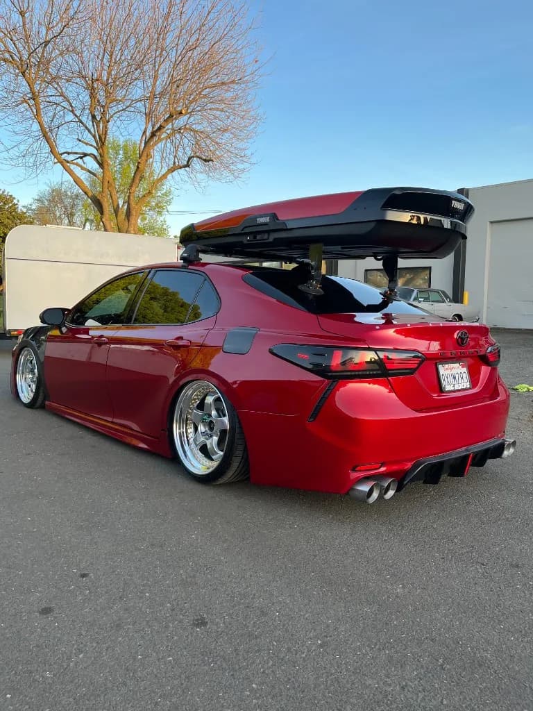 Red slammed Toyota Camry rear three-quarter after detailing