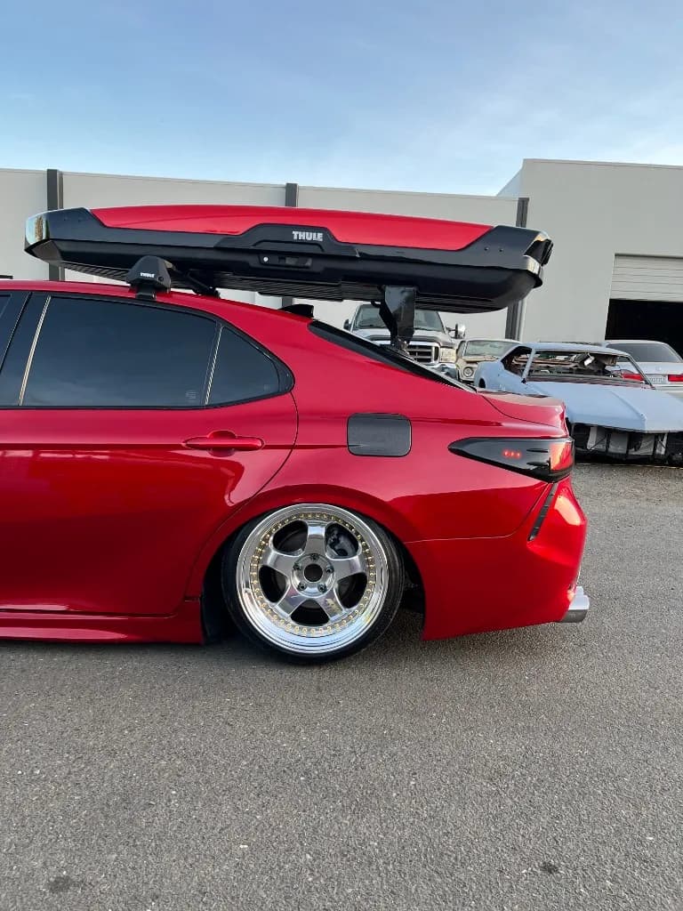 Rear quarter and roof box of a red Toyota Camry after detailing