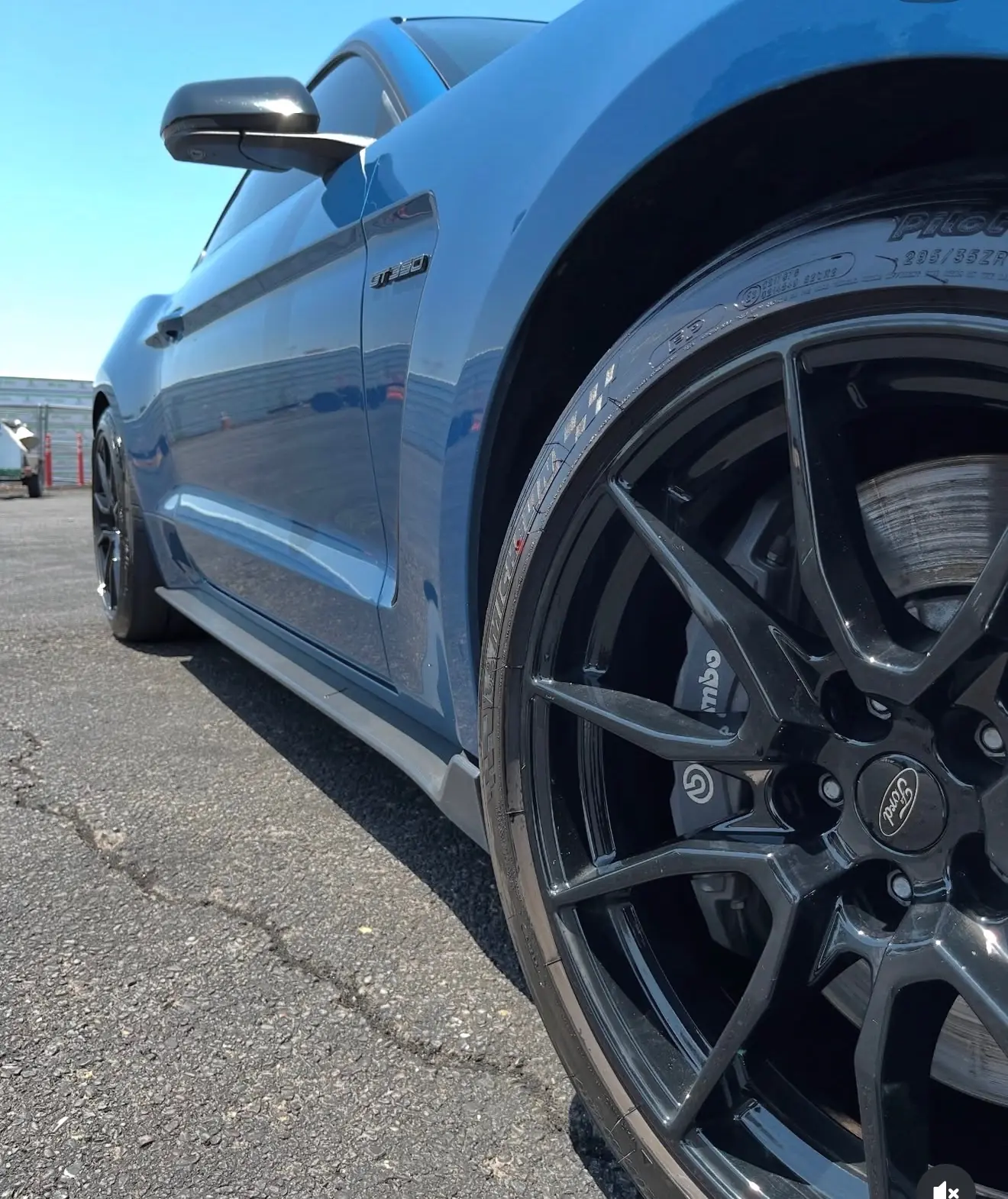 Close detail of a blue Shelby GT350 wheel and lower bodywork after detailing