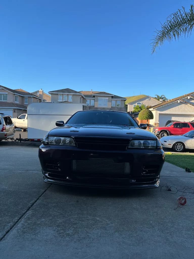 Front of a dark purple Nissan Skyline R32 after exterior detailing