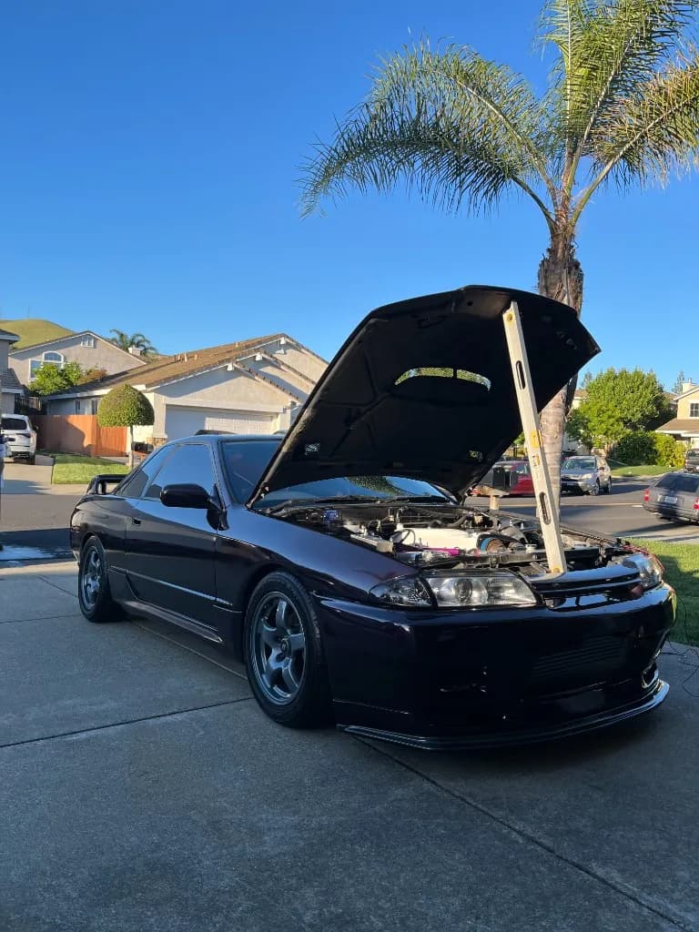 Front of a dark purple Nissan Skyline R32 after exterior detailing