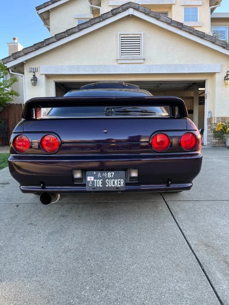 Rear of a dark purple Nissan Skyline R32 after exterior detailing