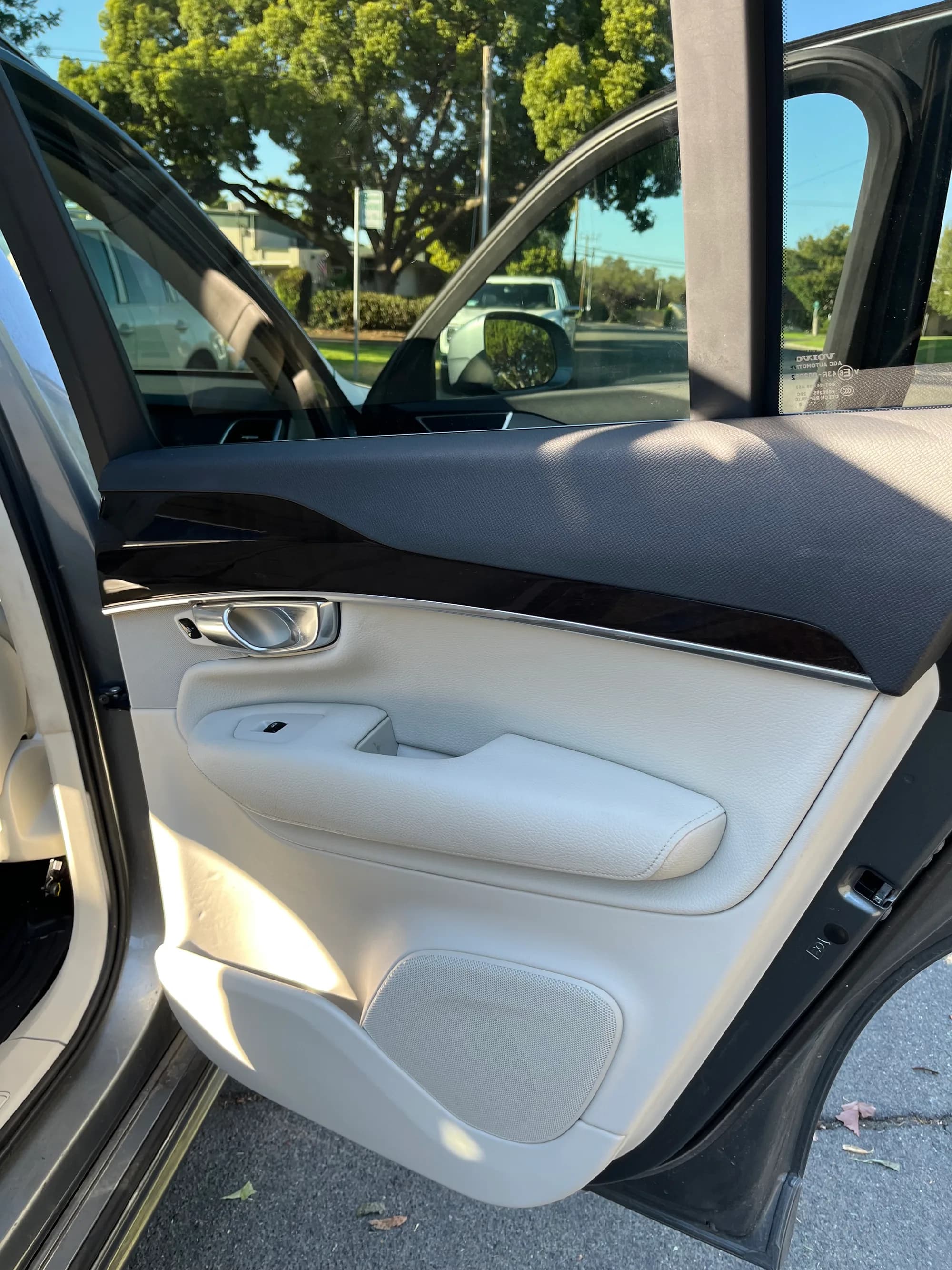 Beige leather door panel and armrest of a Volvo after interior detailing
