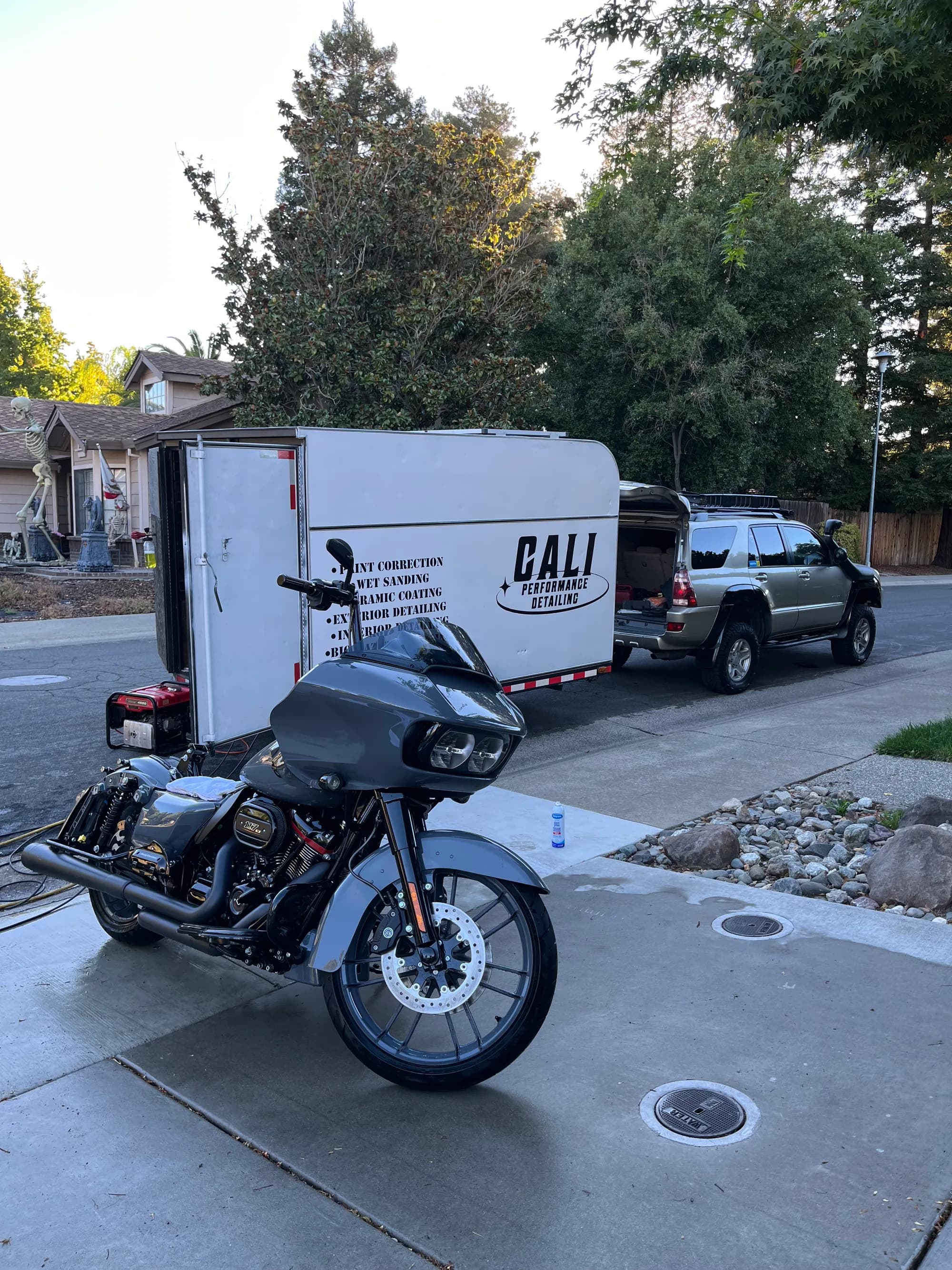 Gray Harley-Davidson after detailing in front of the Cali Performance Detailing trailer